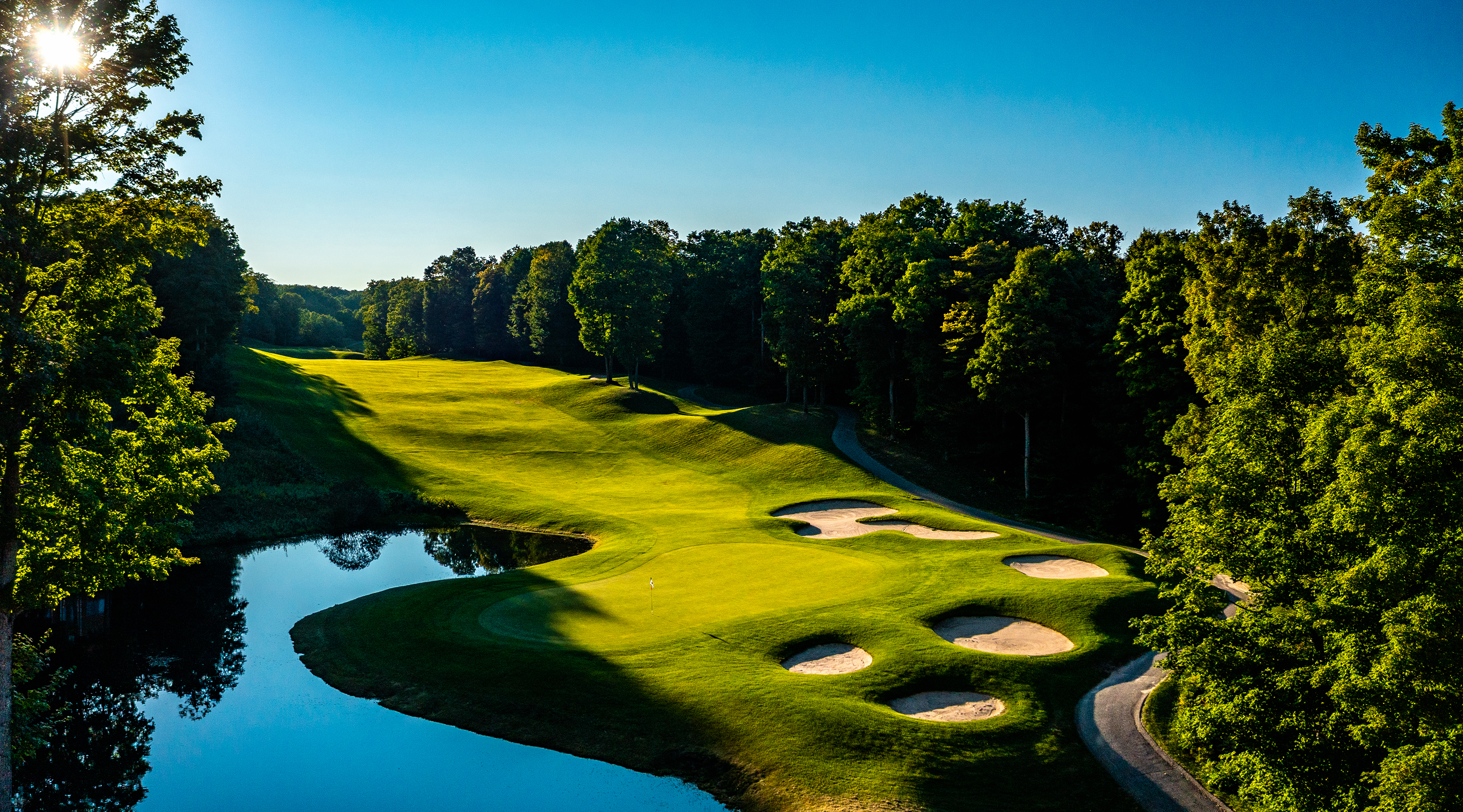 The spectacular 18th hole of Cedar River GC is one of the 90 holes of golf available at Shanty Creek Resort Photo 2