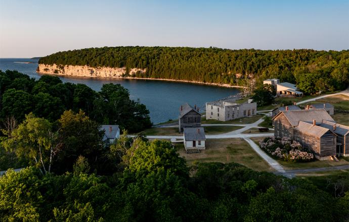 aerial view of fayette state museum along the upper peninsula coastline. sunny day.