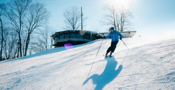 skier coming down the hill on a sunny day