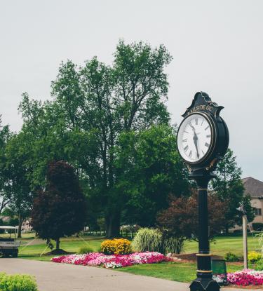 view of course and club from the drive, tall clock in the drive