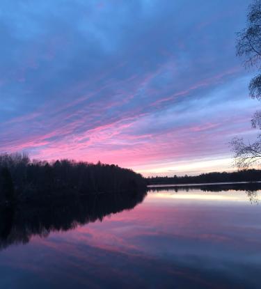 sunset over the lake, pinks and blues mirror from the sky into the lake