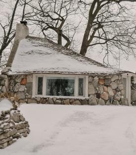 mushroom house covered in the snow on a cloudy day