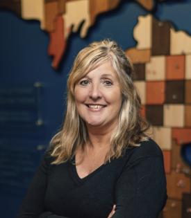 Bonnie standing in front of the state map inside the office