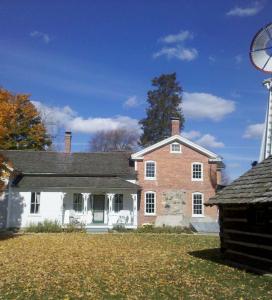brick museum and school house, large windmill and small wooden shed to the right of the windmill