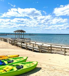 park with large wooden boardwalk between beach and lake huron
