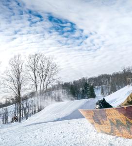 A snowboarder resting on a slope