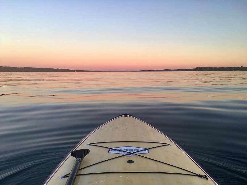 Stand-up paddleboarding on Torch Lake