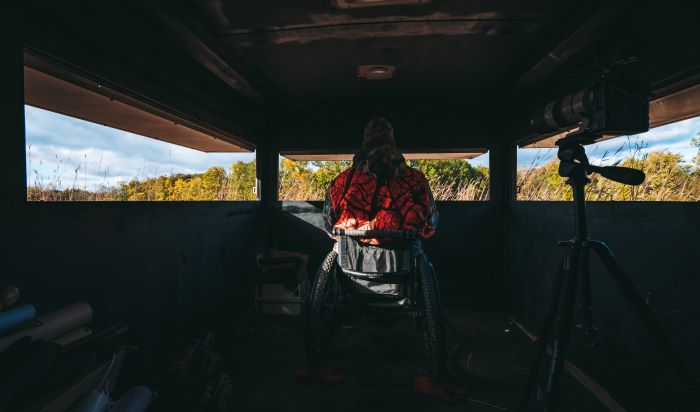 Hunter in wheelchair accessible deer blind