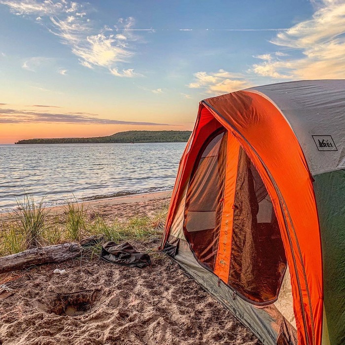 Tent on shore in Munising at sunset