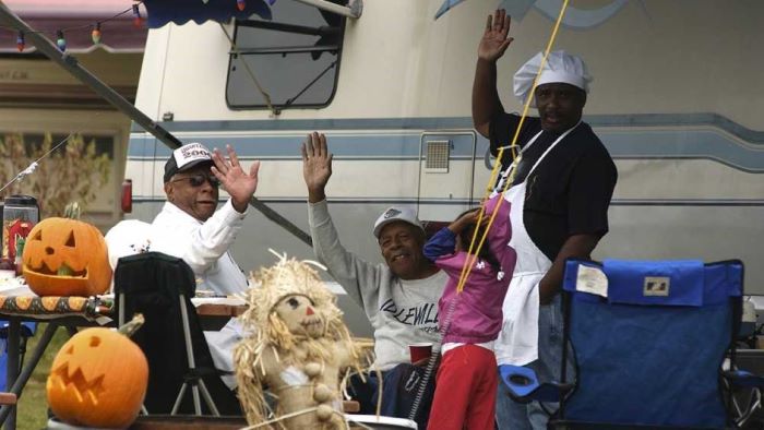 Campers on their campsite wave happily