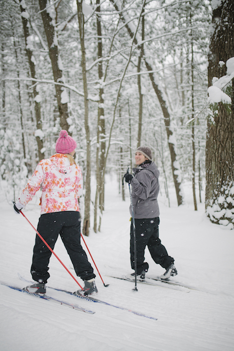 Friends cross-country ski in Michigan