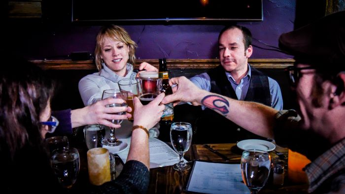 Group of friends sharing a toast at Court Yard Ristorante & Olde Roost Lounge