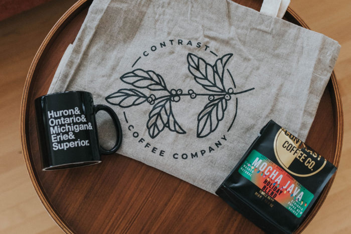I tote bag, coffee mug, and bag of coffee beans.