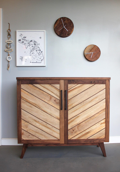 Wooden cabinet and wall clocks displayed at Long White Beard.