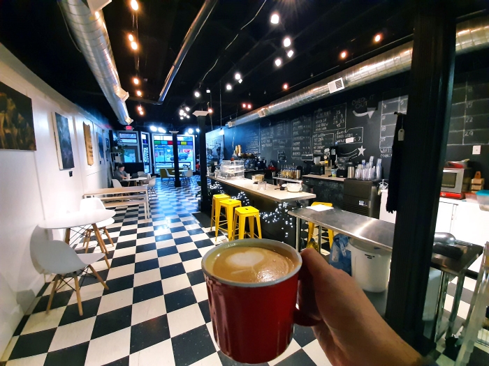 A mug of latte inside the Left Field on Main coffee shop
