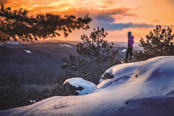Woman snowshoeing on Sugarloaf Mountain near Marquette.